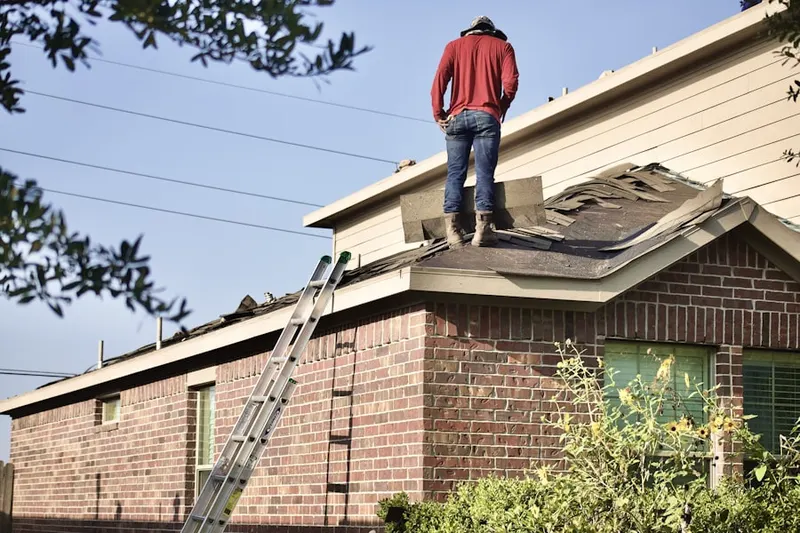 Professional roofer working on a residential roof in Bannockburn Estates